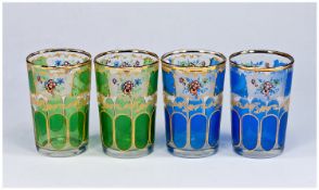 Set of Four Small Glass Tumblers with printed designs including 2 floral panels each, 2 in green, 2