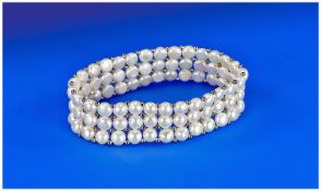 White Cultured Pearl Three Row Bracelet, slightly domed lustrous coin pearls interspaced with small