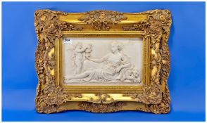 Modern Cast Wall Plaque Showing A Classical Maiden And Cherub, Broad Gilt Frame.