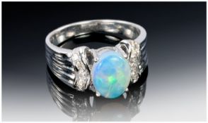 Ladies 18ct White Gold Set Opal and Diamond Ring, the oval opal set with diamonds to the shoulders,