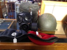 Military Helmet Together With A Gas Mask And Two Berries, One With ATC Badge The Other With
