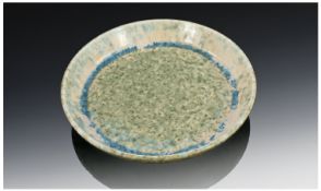 Ruskin Pottery. A Round dish with raised sides executed in a crystalline cream blue and grey