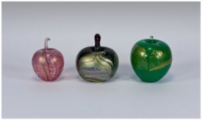 Three Apple Shaped Glass Paperweights comprising 1 Okra with silver/green lustre on a deep blue/