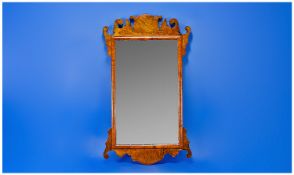 1920`s Walnut Veneered Wall Hanging Mirror, with a shaped frame, fitted with plain glass, moulded