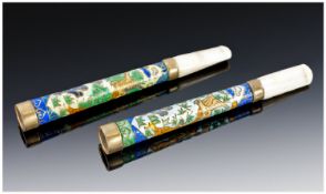 A Fine Quality Pair Of Chinese Cigarette Holders, the body is in cloisonne enamel depicting a bird