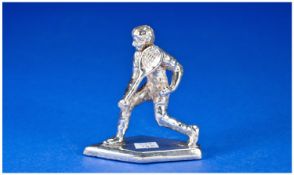 A Silver Model Of A Tennis Player In Action. Unmarked but tests silver. Filled. 3`` in height.