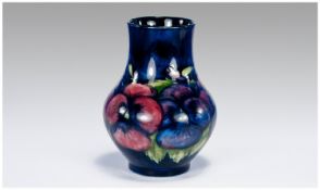 W.Moorcroft Vase ``Pansy`` Design on Blue Ground Restoral and Overpainting to top 1/3 of the Vase.