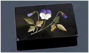 A Victorian Black Polished Derbyshire Slate Pietra Dura Paperweight with an inlaid violet flower.