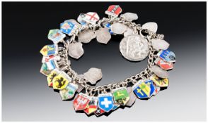 Silver And Enamel Charm Bracelet with silver St Christopher and European Towns Plaque. Mostly