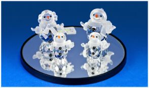 Swarovski Crystal Snowman Family 4 pieces, comprising snowman, snowwoman with purse, and two little