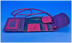 Tula Colour Block Leather Travel Pouch in magenta, purple and navy blue, containing a variety of