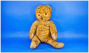 Large Knitted Teddy Bear, early 20th century, in a golden colour, with amber coloured glass eyes,