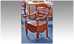 Early 19th Century Mahogany Commode Chair, with large crest rail, central bar below, turned