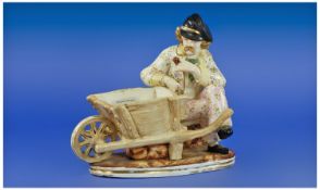 Figural Posy Holder showing man in florally hand painted suit with jaunty black cap, smoking a