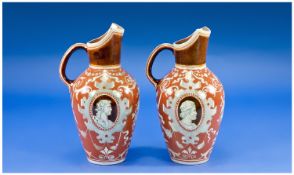 Pair of Doulton Ewers, circa 1910, each with a French portrait panel to each side, surrounded by