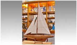 Large Model of a 20th Century Yacht, with linen sails, raised on a detachable stand.