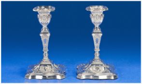 A Victorian Silver Pair of Ornate and Embossed Table Candlesticks. Detachable Nozzles, of Good