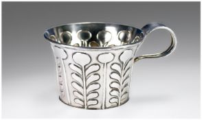 An Unusual Loop Handled Silver Cup. The outer decorated in relief with a stylised tree of life