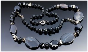 Black and Banded Agate Long Layered Necklace, showing a variety of shapes of black agate beads with