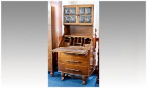1930`s Oak Bureau Cabinet, with two glazed doors to top, shelf below, the fall front opening to