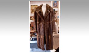 Ladies Three Quarter Length Dark Brown Musquash Coat. Half tie belt, fully lined.