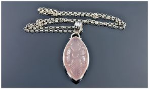 A Sterling Silver Pendant and Chain set with an elliptical shaped pale pink chalcedony hard stone