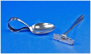 A Silver Caddy Spoon, Hallmark Birmingham 1928, 3.25`` in length. Together with a silver scrapper,