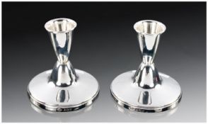 A Stylish Pair Of Silver Dwarf Candlesticks. Double measure shape on a domed spreading foot. Fully