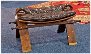 Camel Stool, possibly made from Padouk, with removable leather buttoned cushion, raised on splayed