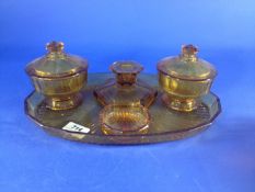 Early 20th Century Amber Coloured Dressing Table Set, comprising candlestick, two lidded pots, pin