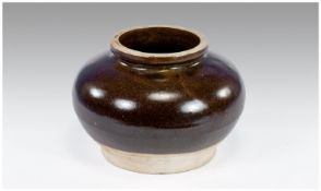 A Chinese Northern Blackware Jar of Compressed Form, the lower body and base unglazed. Song/Yuan