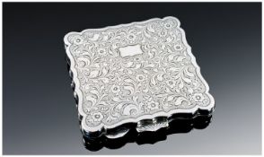 A Continental Shaped Square Silver Compact with sunburst clasp and floral engraved decoration