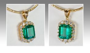 A Natural Transparent Green Single Stone Emerald & Diamond Pendant, of fine quality. Supported on