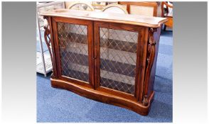 Early Victorian Rosewood Credenza, of serpentine form, moulded top, comprising two doors, each