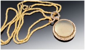 Victorian 9 Carat Gold Locket supported on a gold plated chain..