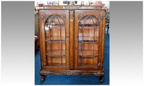 1930`s Oak Display Cabinet, fashioned in the Jacobean style, fitted with two glazed doors opening