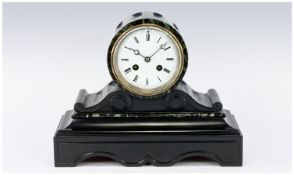 A Fine French Black Marble and Slate Mantle Clock with barrel and scroll design, glass back and