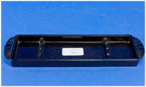 An Art Deco Bakelite Pen/Pencil Tray with Odeonesqe ends and cradles for four items. Trade mark `S`