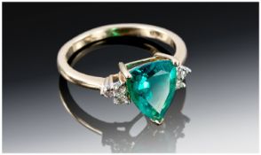 10ct Gold Dress Ring, Set With A Triangular Cut Green Faceted Stone Set Between Six Round Brilliant