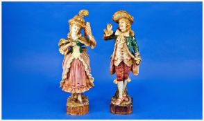 Pair of Majolica Figures in Eighteenth Century Dress in matching colours of teal, lemon and rose