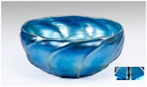 A Fine And Large Iridescent Bright Peacock Blue Tiffany Bowl with ribs in glass around the