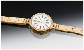 Everite Ladies 9ct Gold Case Wristwatch supported on a gold plated bracelet.