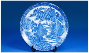 Japanese, 18th/19th Century, blue and white plate with mountain scene and 3 motifs to the base. 12