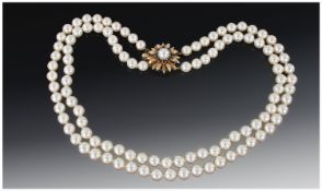 A Fine Two Strand Cultured Pearl Necklace, with 14ct gold set Sapphire and Pearl clasp. Of good