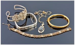 A Ladies Silver Bangle 16.8 grams plus a silver coloured bangle with a pierced work and a gold