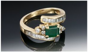 18ct Gold Emerald & Diamond Ring, The centre emerald flanked by six small diamonds with a further 30