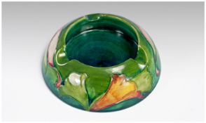 Moorcroft Lilies Pattern Ashtray on green ground. 5.5 inches in diameter.