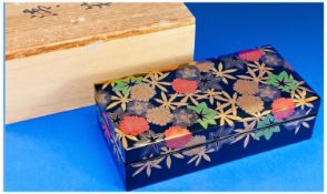 A Quality Japanese Black Lacquer and Cloisonne Rectangular Box with pull off lid which has canted