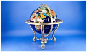 Modern Gemstone Globe, raised on a brass stand, supported on three legs, measuring 18 inches high.