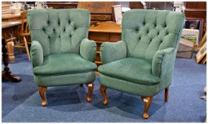 Pair of Classic Upholstered Winged Armchairs, each upholstered in green patterned fabric, with